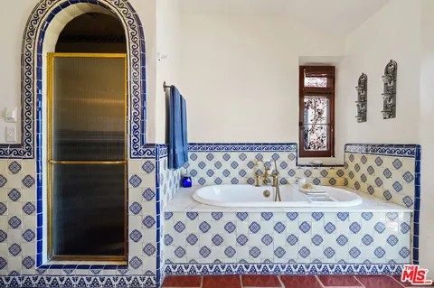 a bathroom with a sink mirror and vanity