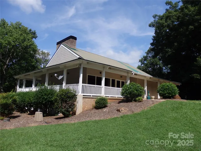 a swimming pool with wooden fence and trees in the background