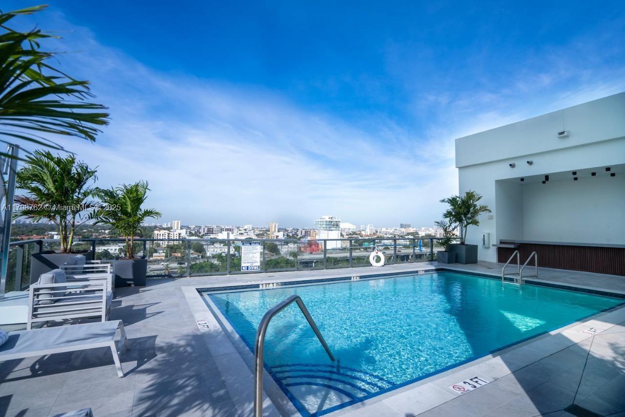 a swimming pool with outdoor seating and plants