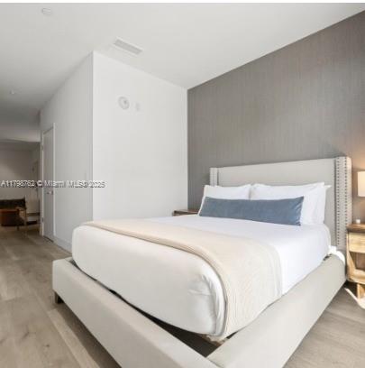 229 Southwest 9th Street, Unit 404 Miami, FL 33130 - Photo 10 of 11 a bedroom with a bed and a couch