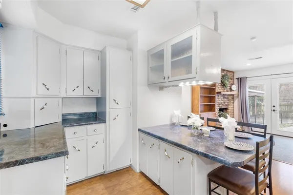 a kitchen with granite countertop a sink and cabinets