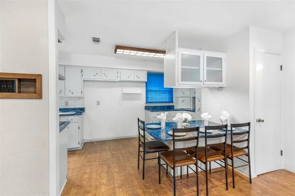 a kitchen with a table chairs and a refrigerator