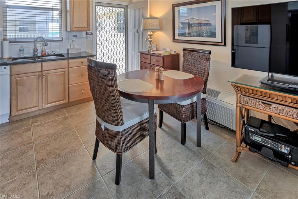 5900 Bonita Beach Road Southwest, Unit 1004 Bonita Springs, FL 34134 - Photo 11 of 27 a dining room with furniture and window
