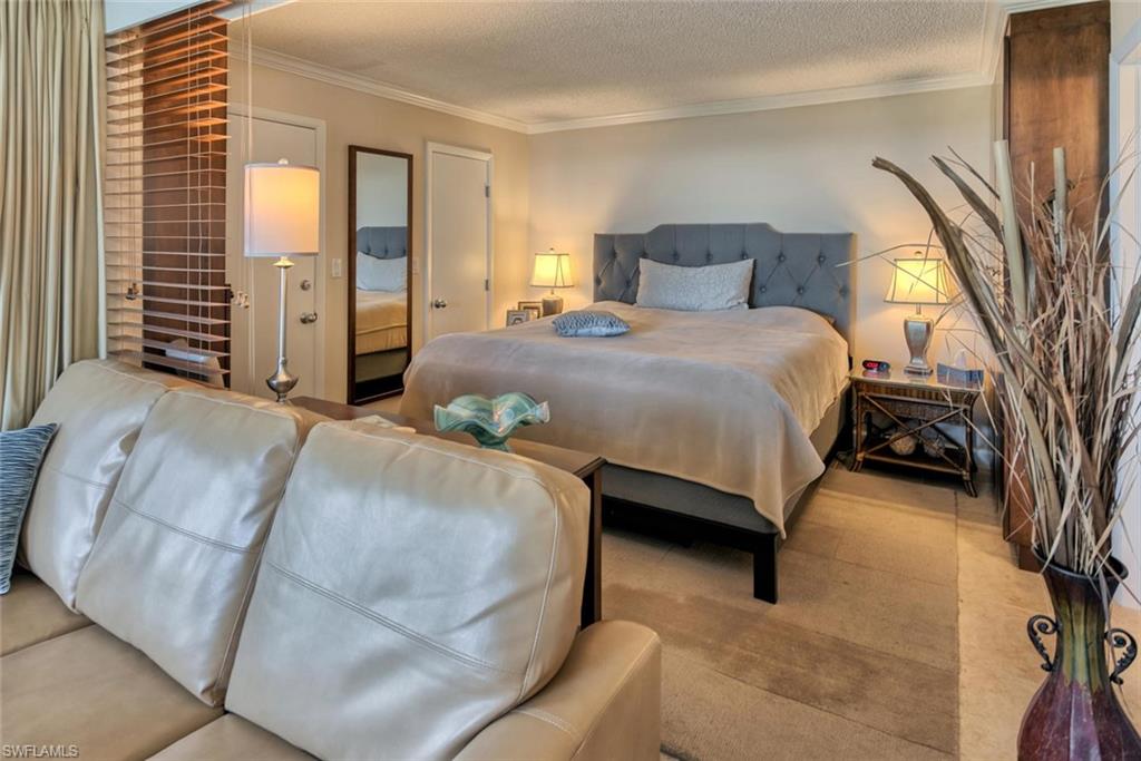 5900 Bonita Beach Road Southwest, Unit 1004 Bonita Springs, FL 34134 - Photo 12 of 27 a bedroom with a bed and a night stand