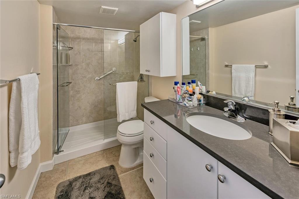 5900 Bonita Beach Road Southwest, Unit 1004 Bonita Springs, FL 34134 - Photo 14 of 27 a bathroom with a sink toilet and shower