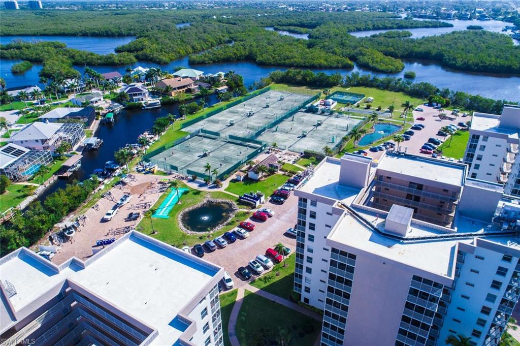 5900 Bonita Beach Road Southwest, Unit 1004 Bonita Springs, FL 34134 - Photo 19 of 27 an aerial view of a house yard and swimming pool