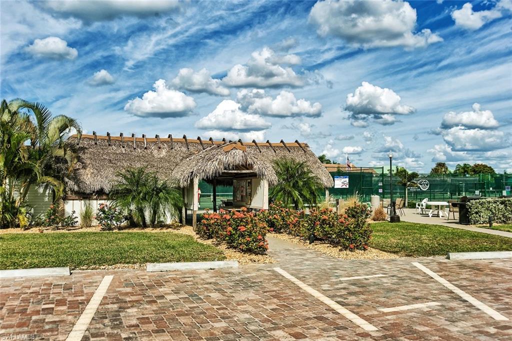 5900 Bonita Beach Road Southwest, Unit 1004 Bonita Springs, FL 34134 - Photo 22 of 27 a view of a house with a yard