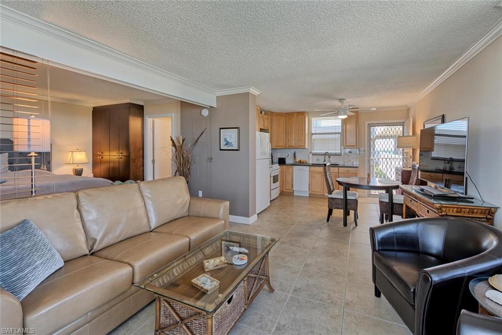 5900 Bonita Beach Road Southwest, Unit 1004 Bonita Springs, FL 34134 - Photo 5 of 27 a living room with furniture and a flat screen tv