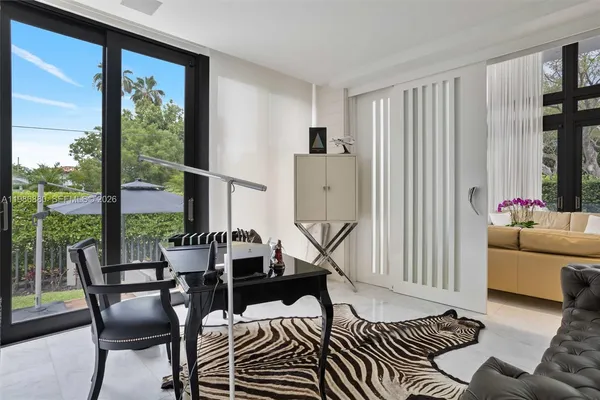 a kitchen with stainless steel appliances kitchen island granite countertop a sink and a refrigerator