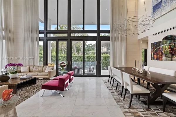 a living room with furniture and floor to ceiling windows
