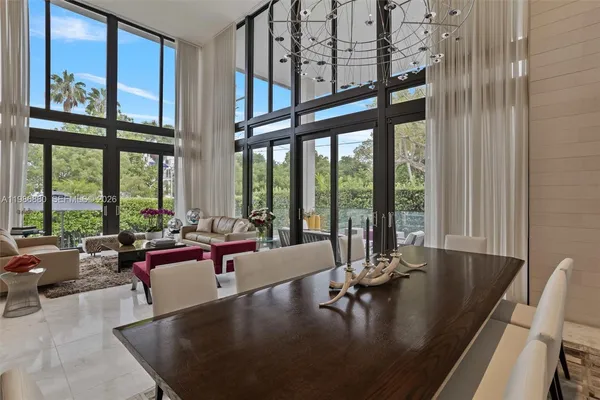 a living room with furniture and a floor to ceiling window