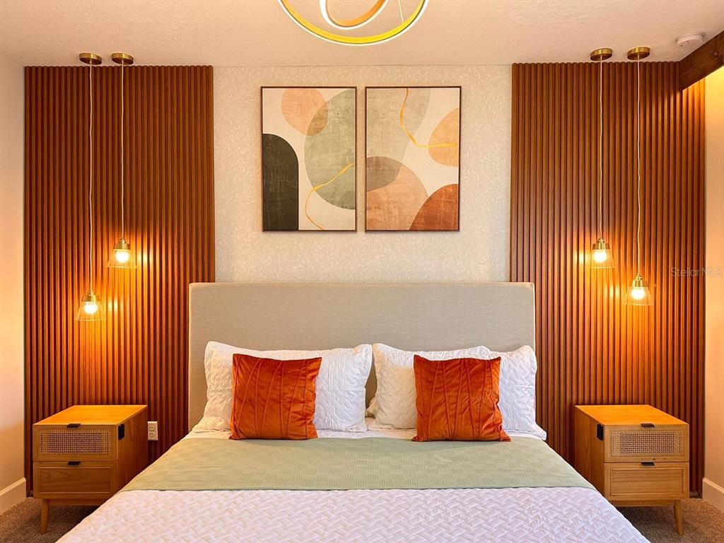 304 Villa Domani Court Davenport, FL 33896 - Photo 17 of 37 a bedroom with a bed and wooden floor