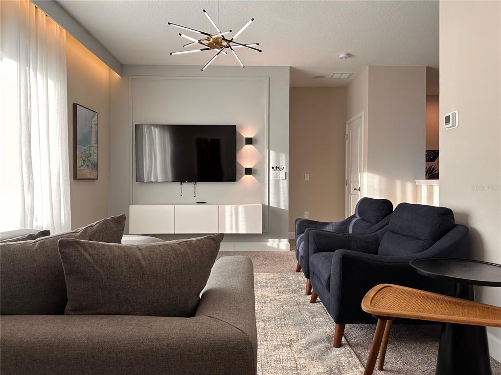 304 Villa Domani Court Davenport, FL 33896 - Photo 19 of 37 a living room with furniture and a flat screen tv