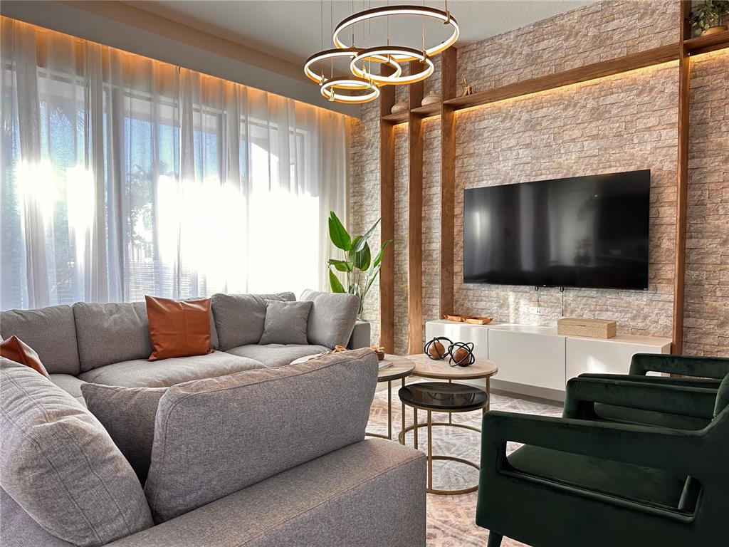 304 Villa Domani Court Davenport, FL 33896 - Photo 3 of 37 a living room with furniture and a flat screen tv