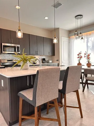 a kitchen with a table chairs stove and microwave