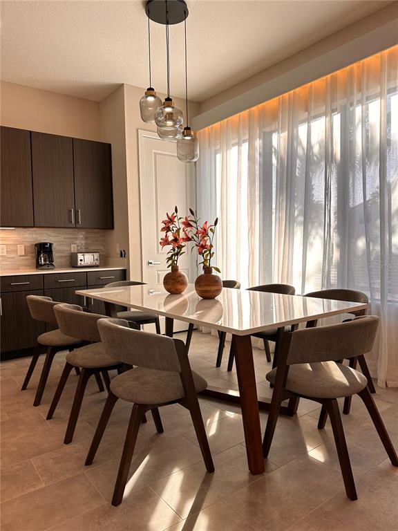 304 Villa Domani Court Davenport, FL 33896 - Photo 7 of 37 a view of a dining room with furniture window and outside view
