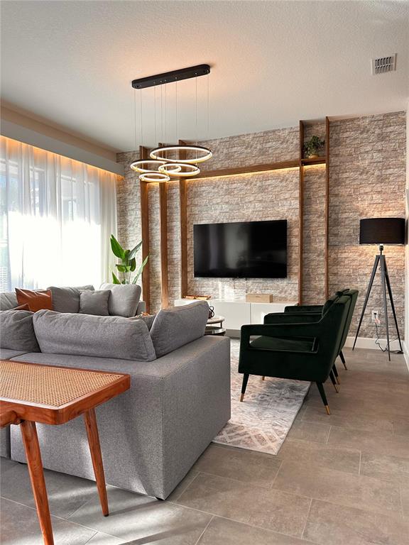 304 Villa Domani Court Davenport, FL 33896 - Photo 8 of 37 a living room with furniture and a flat screen tv