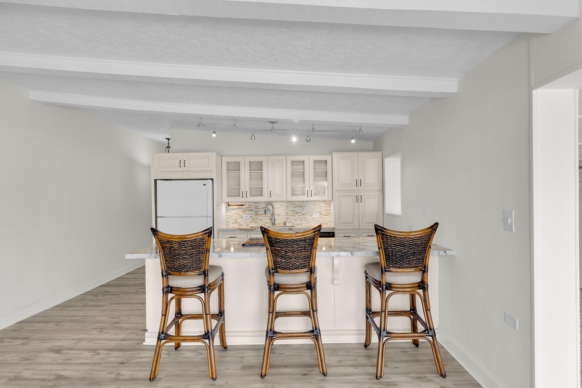 750 9th Street Key Colony Beach, FL 33051 - Photo 11 of 30 a view of a dining room with furniture and wooden floor