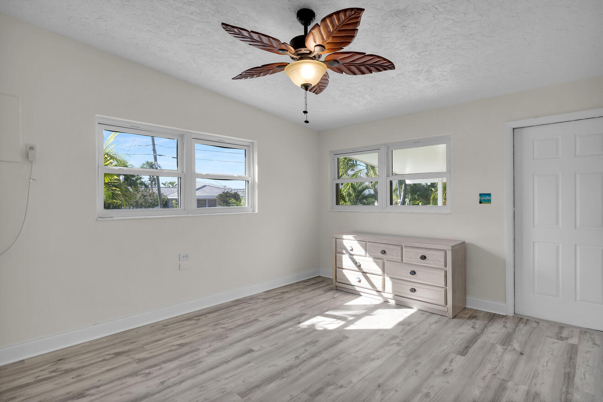 750 9th Street Key Colony Beach, FL 33051 - Photo 20 of 30 a view of an empty room with a window and wooden floor