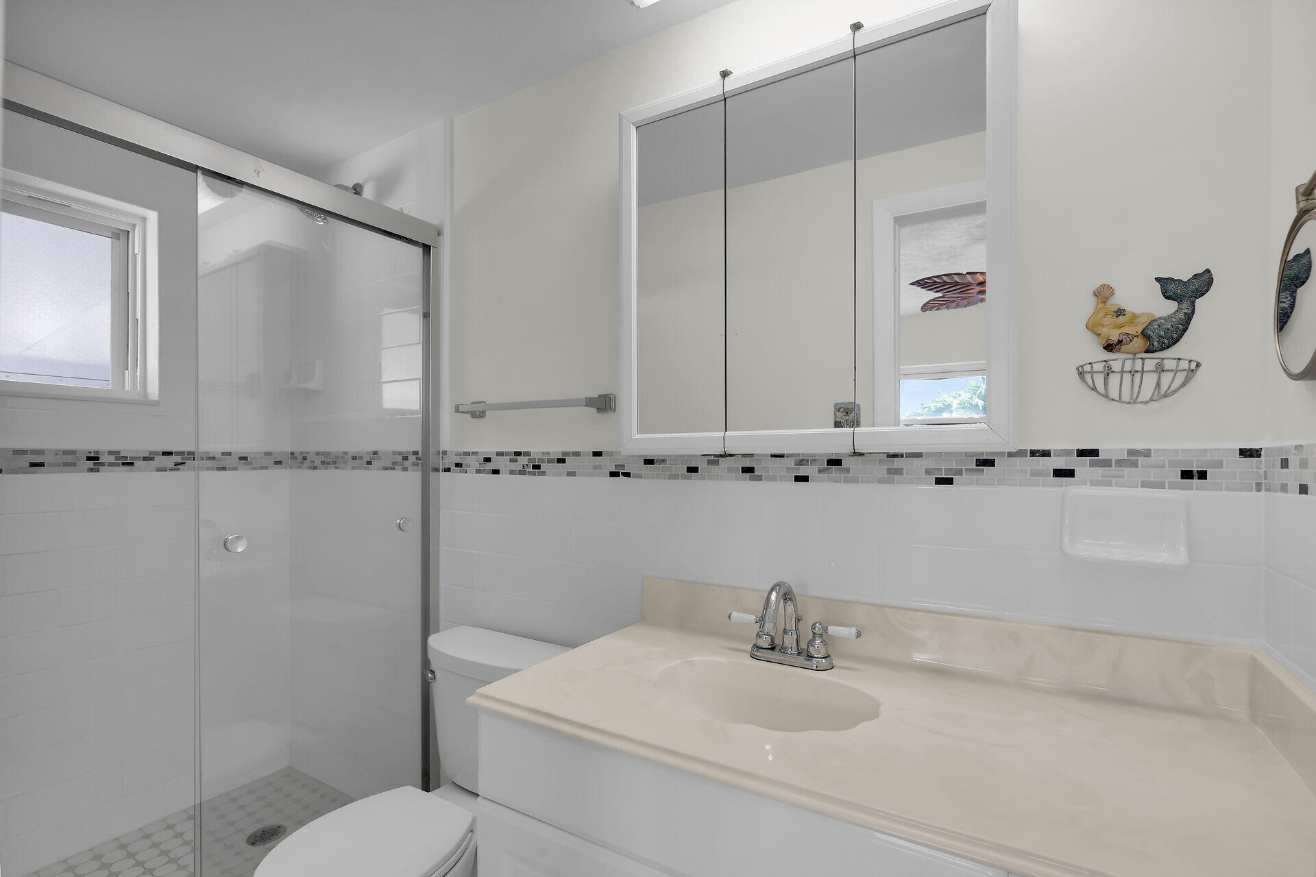 750 9th Street Key Colony Beach, FL 33051 - Photo 23 of 30 a bathroom with a sink and a mirror