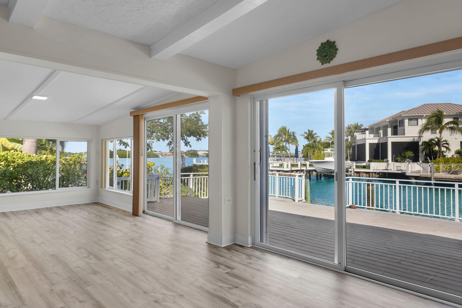 750 9th Street Key Colony Beach, FL 33051 - Photo 9 of 30 an empty room with wooden floor and windows