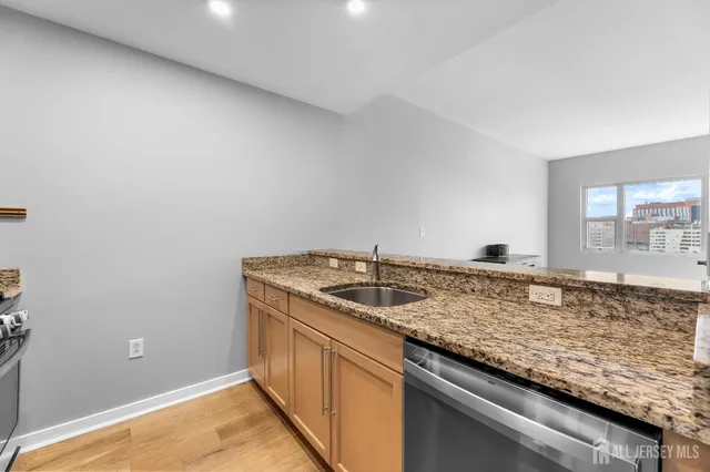 a kitchen with granite countertop cabinets and sink