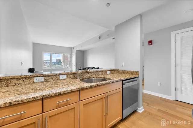 a kitchen with granite countertop a sink and a stove