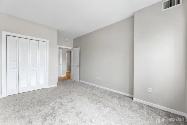 a view of an empty room and closet area