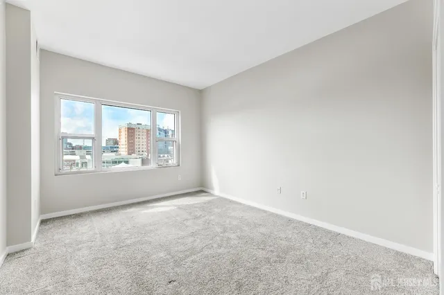a bathroom with a granite countertop sink a toilet a mirror and shower