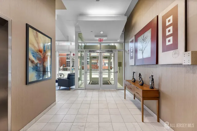 a room with painting on the wall and a large window