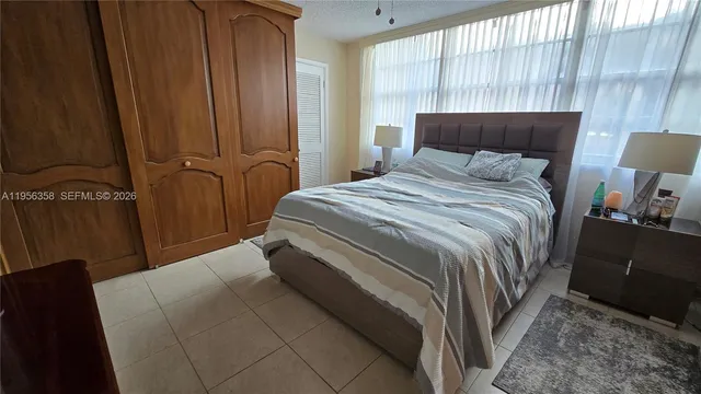 a bedroom with a bed and a night stand