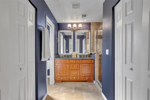 a view of a hallway with granite countertop a couch and cabinets