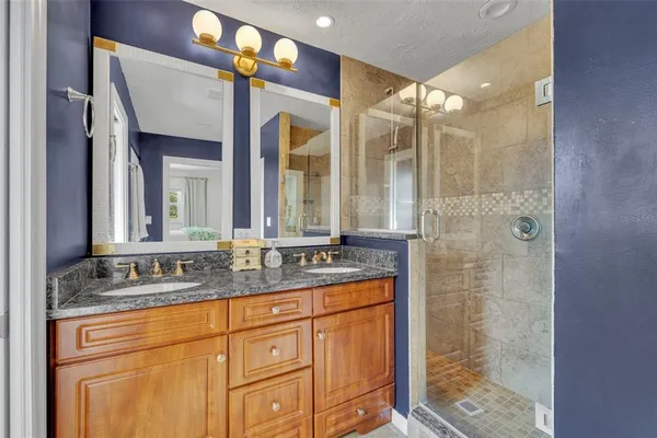 a bathroom with a granite countertop sink mirror and double