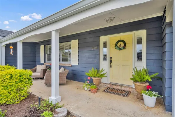 a front view of a house with outdoor seating