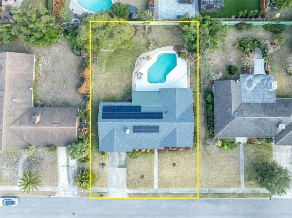 an aerial view of a house with a yard