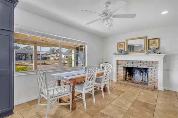 a dining room with furniture a fireplace and a chandelier