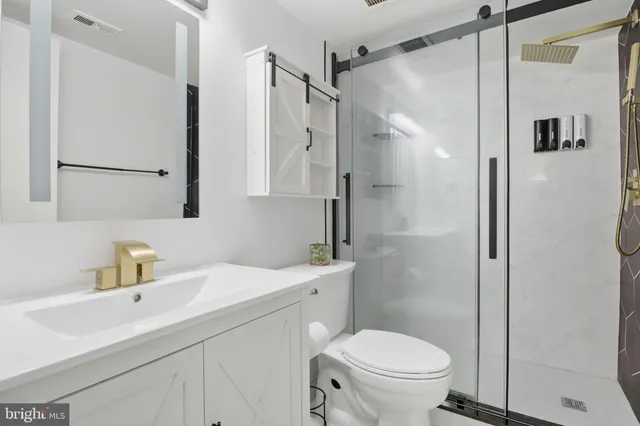 a bathroom with a sink toilet and shower