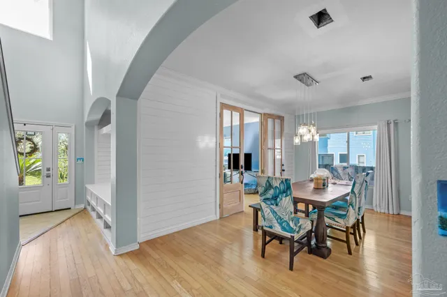 a dining room with furniture and wooden floor