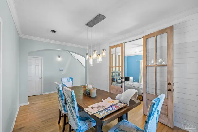 a dining room with furniture and wooden floor