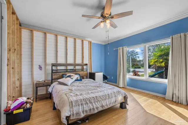 a bedroom with a large bed and a chandelier