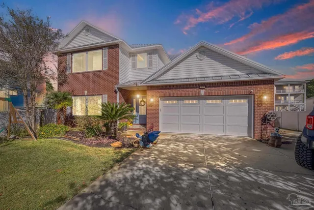 a view of a house with a yard and garage