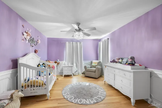 a bedroom with a large bed and a chandelier