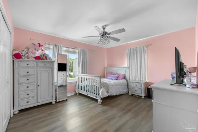 a bedroom with a large bed and a chandelier