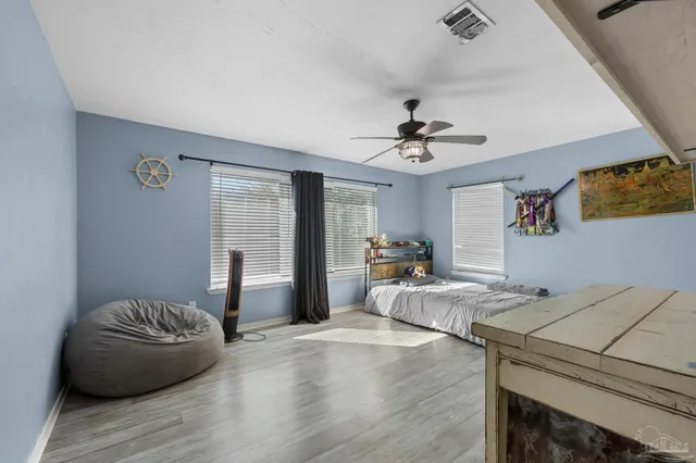 a living room with furniture fireplace and wooden floor