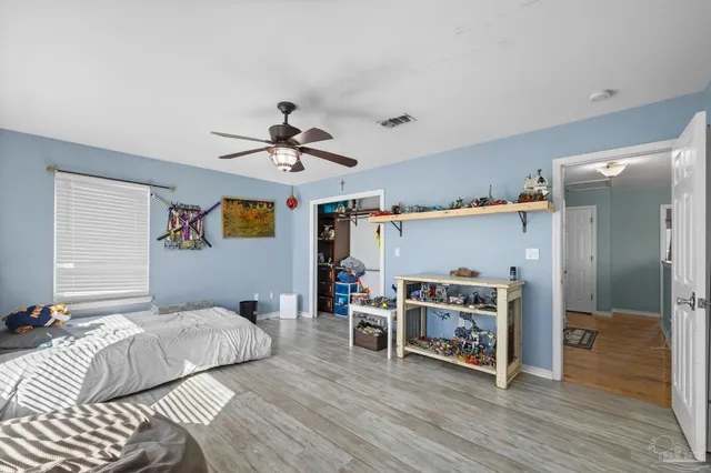 a view of backyard with table and chairs and wooden fence