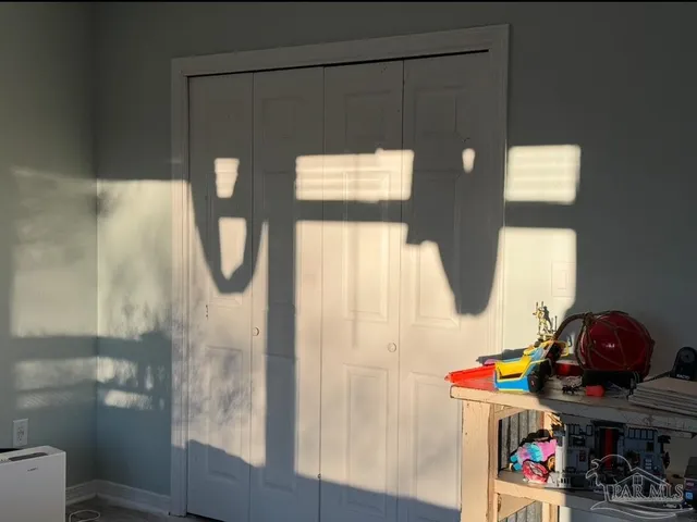 a view of backyard with table and chairs and wooden fence