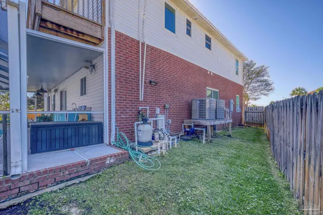 a front view of a house with a yard and tree