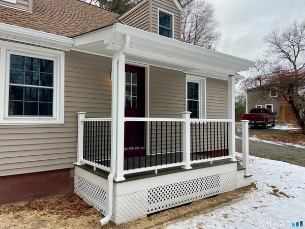 a view of a brick house with wooden fence