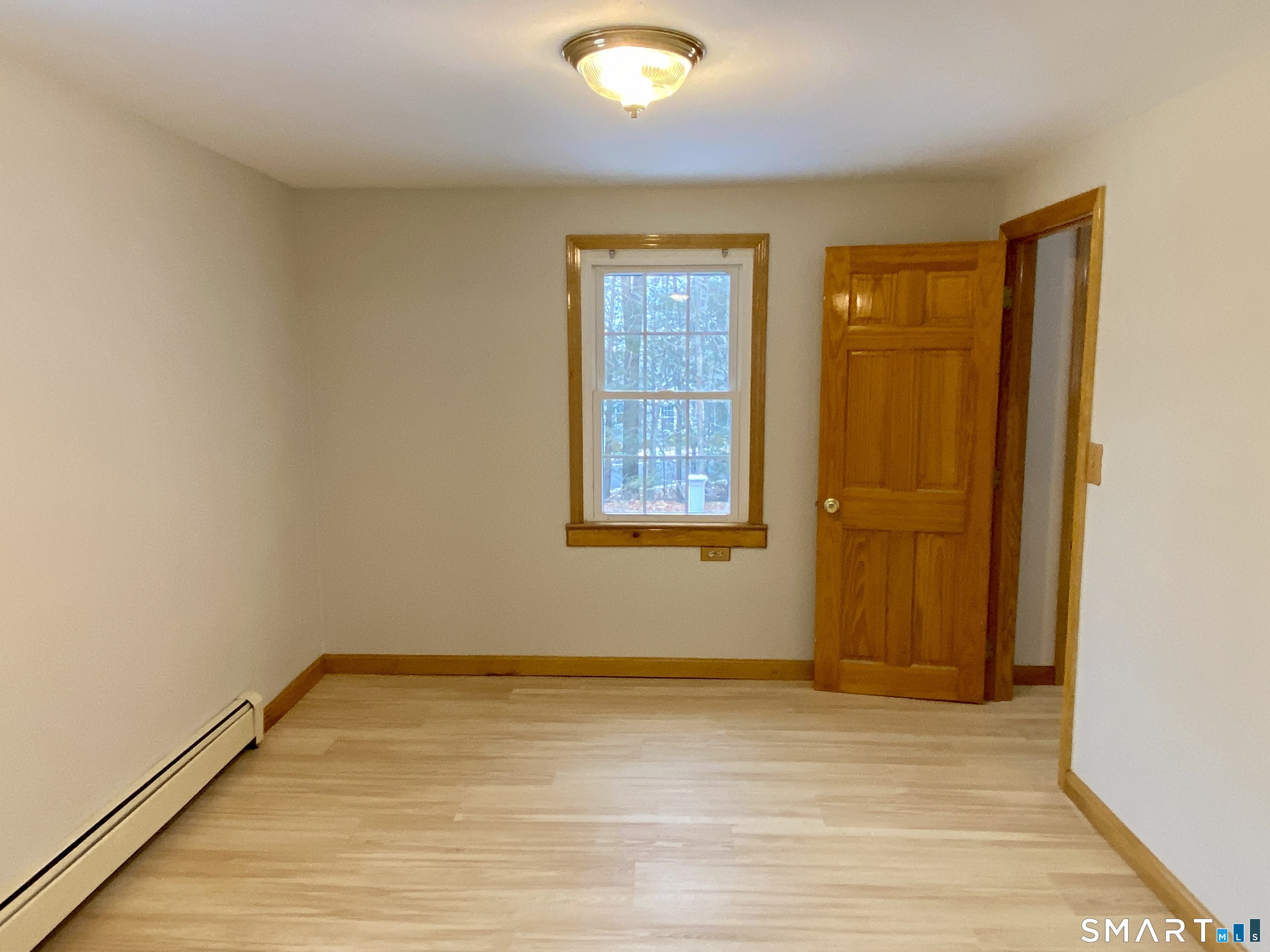 8 S Road Ellington, CT 06029 - Photo 12 of 21 an empty room with wooden floor and windows