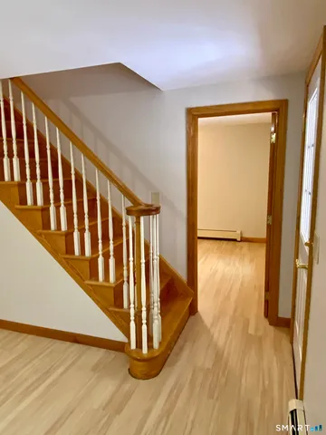 a view of entryway with wooden floor